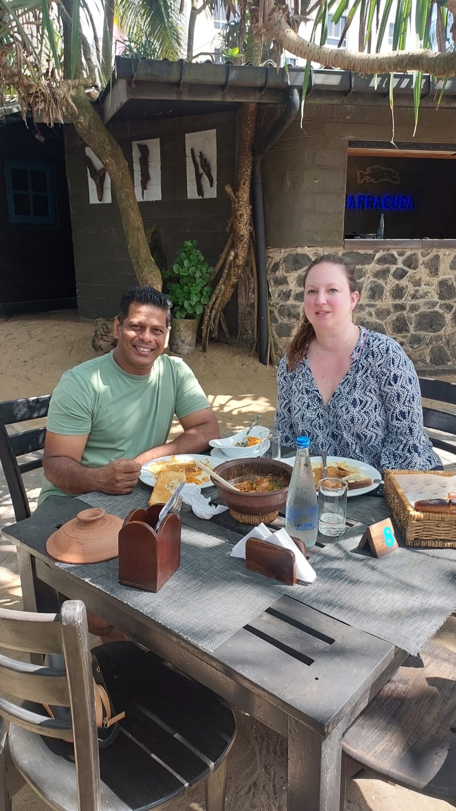 A guest and local guide enjoying an outdoor meal