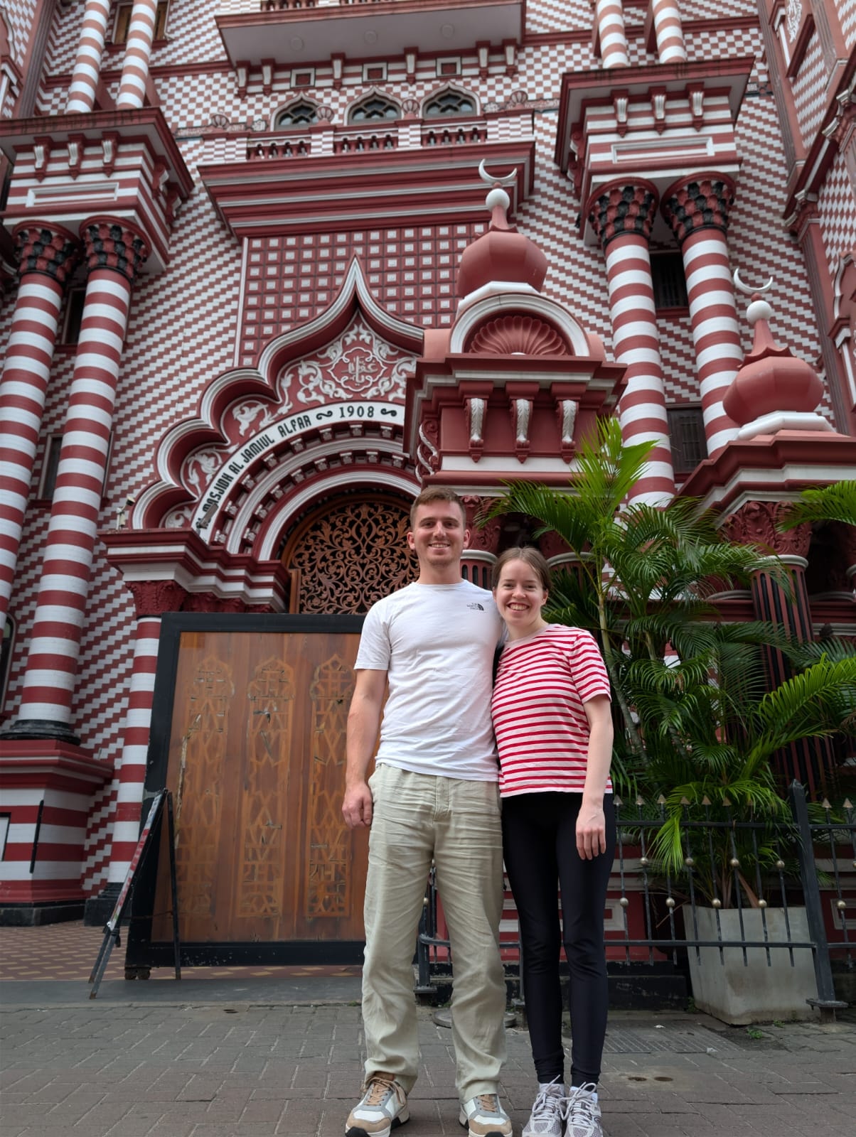Two guests in front of Colombo’s red-and-white mosque